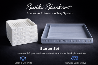 One large grays stackable rhinestone tray with tool holder and four smaller white rhinestone trays.